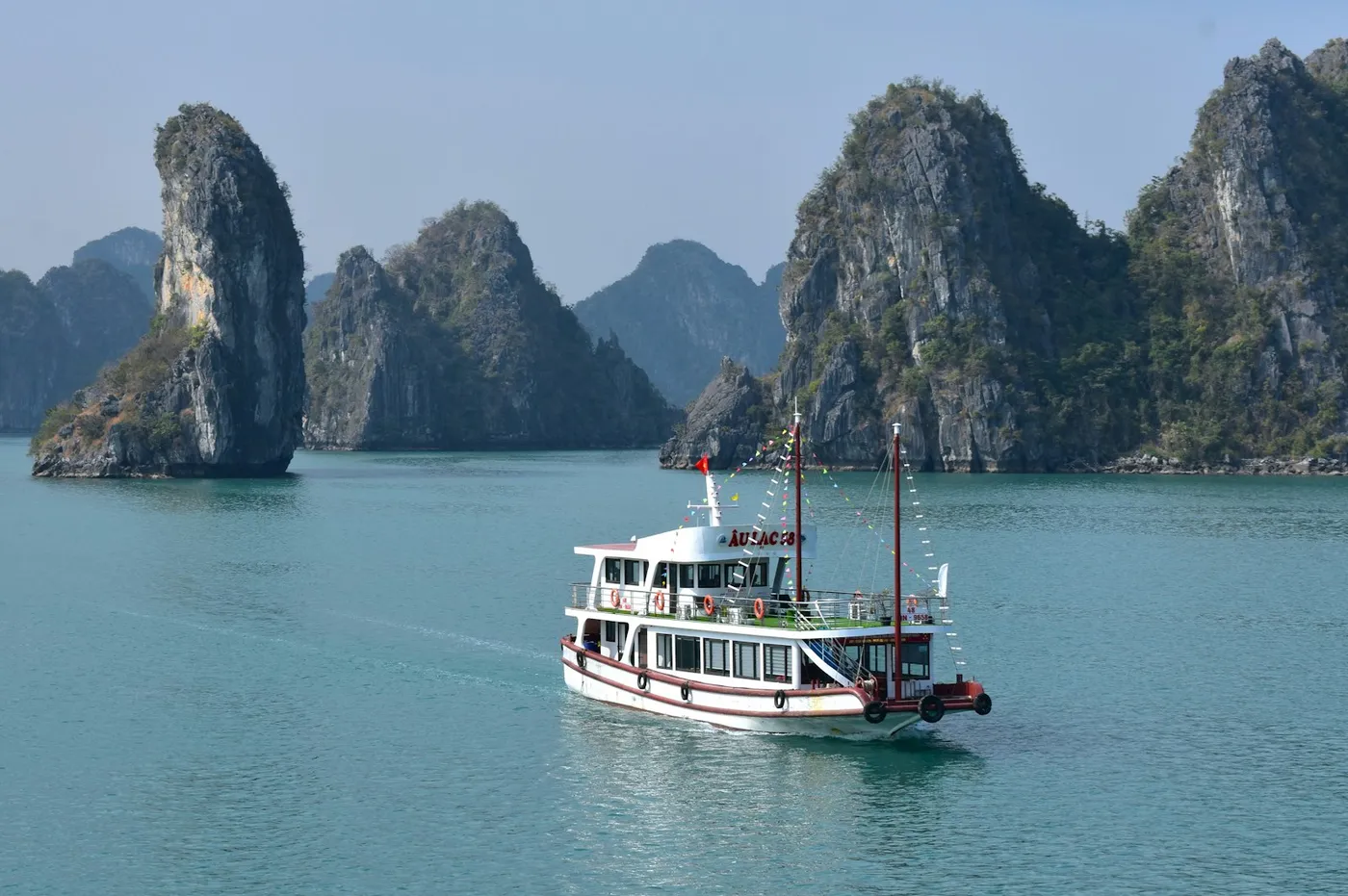 Traditional boat among limestone karsts in Ha Long Bay, Vietnam